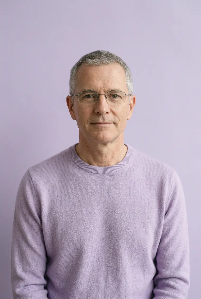 Man in a lilac sweater against a lilac backdrop